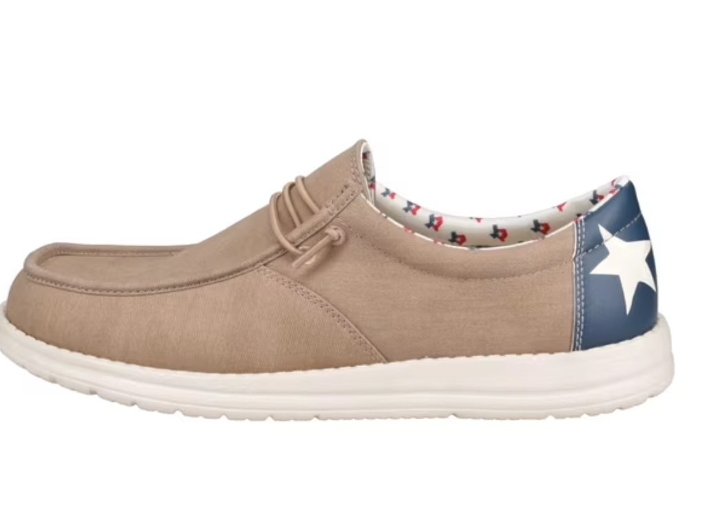 GBX tan canvas moc-toe shoe with navy blue star-printed heel panel and white EVA outsole, side view